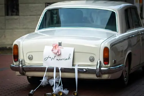 cream Rolls Royce with just married sign at back