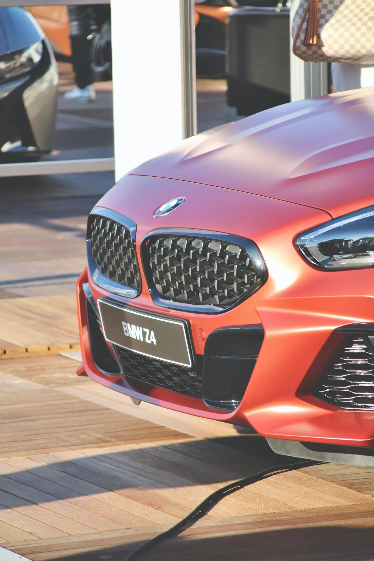 red bmw z4 on a wooden floor