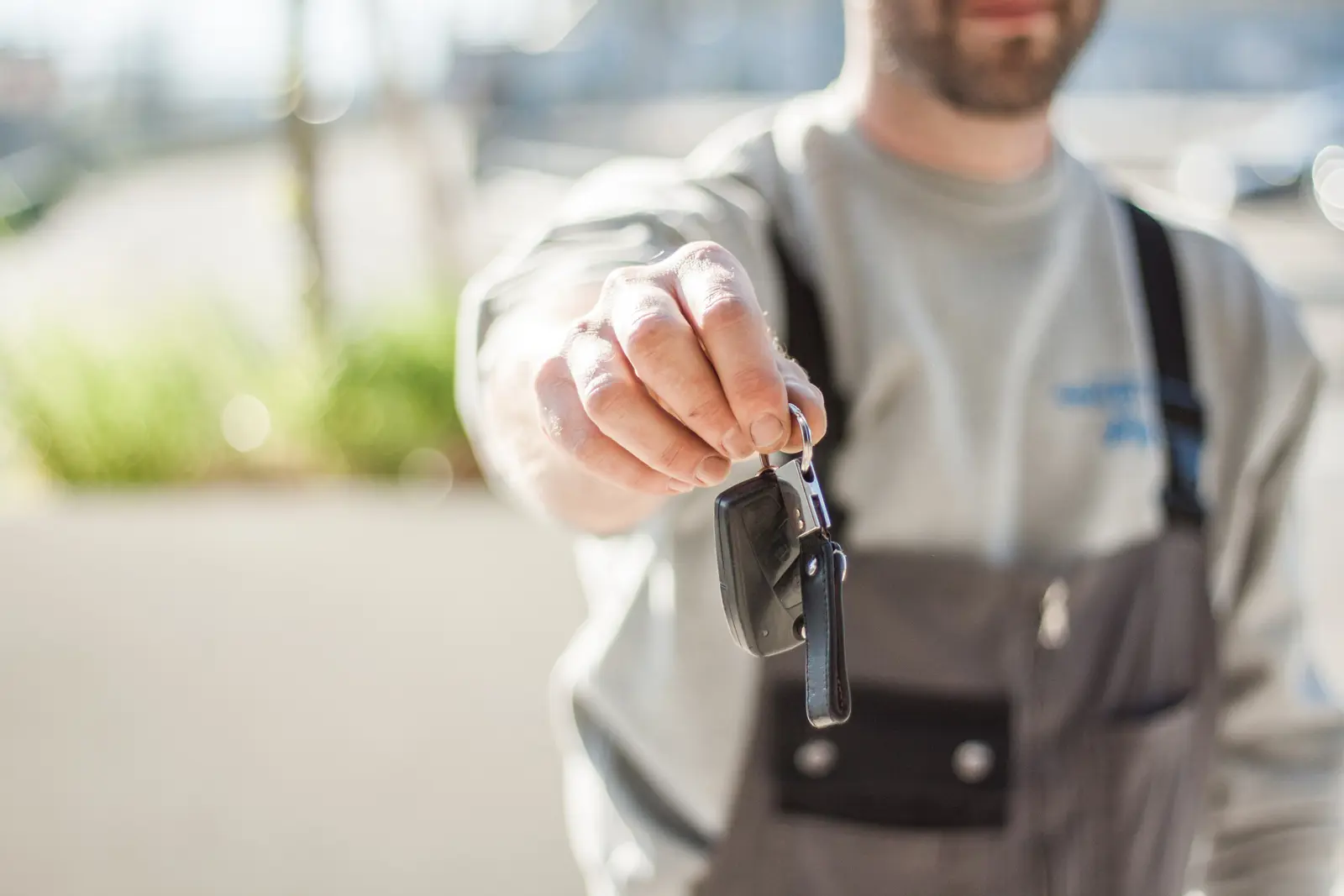 A man handing a set of keys over