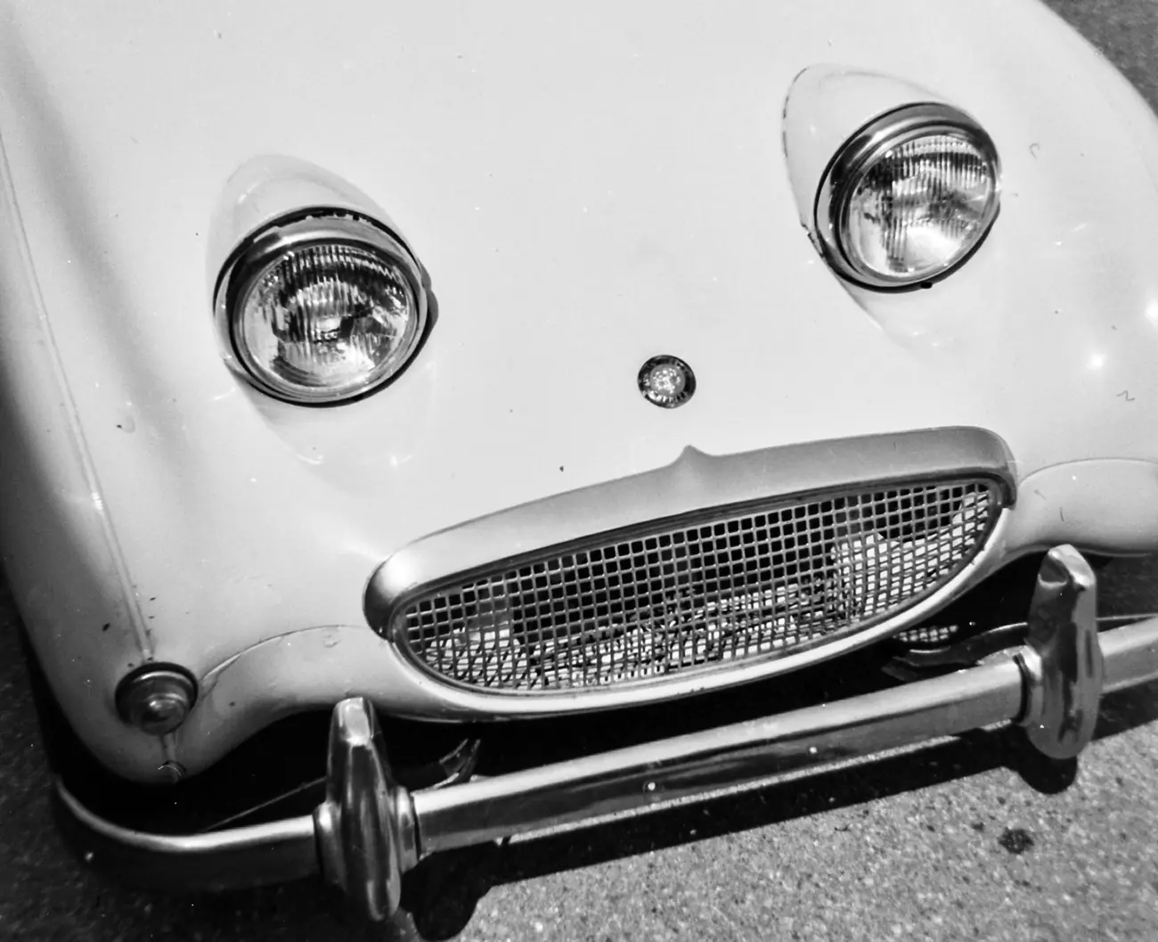 A white Austin Healey Sprite from above