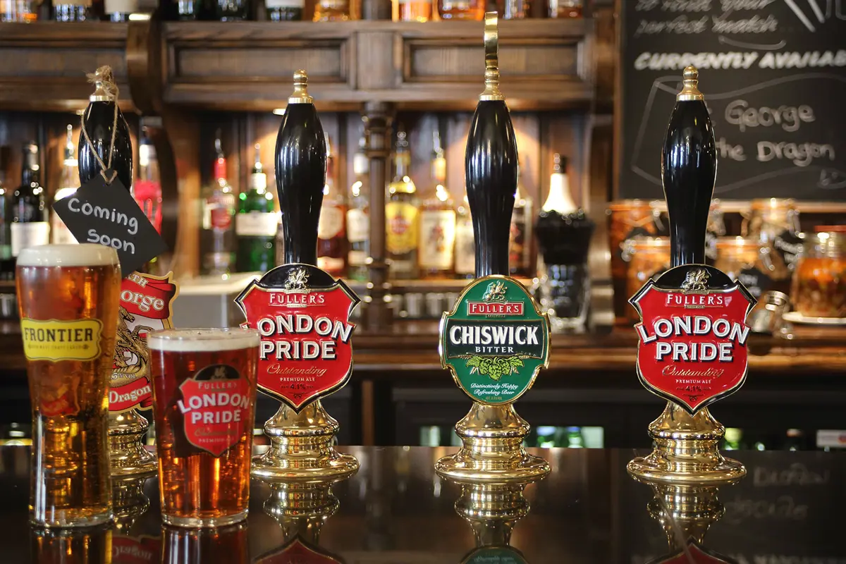 A bar in a pub with different beer taps