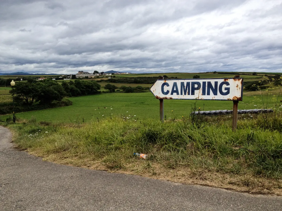 A sign on a corner of a field reading Campsite